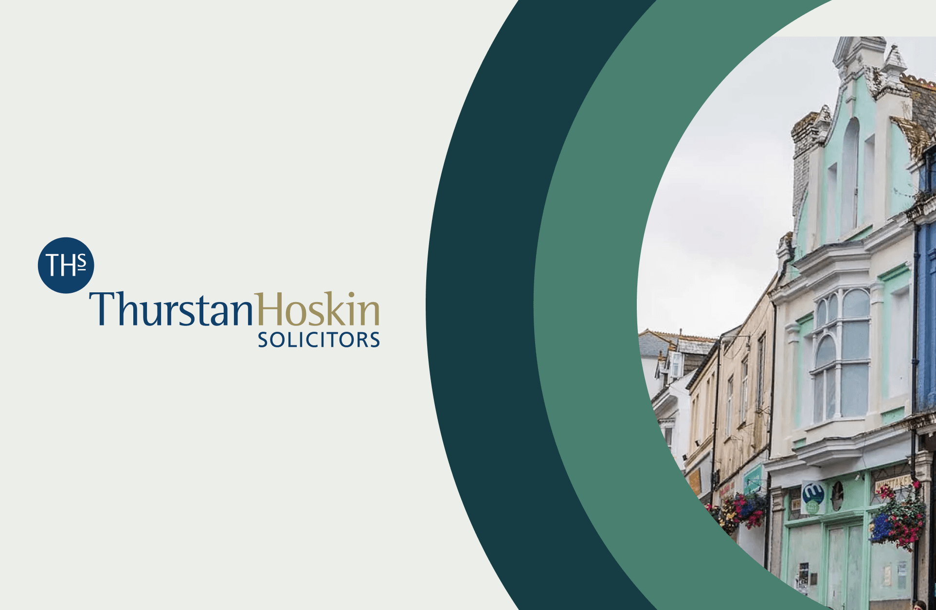 The Thurstan Hoskin Solicitors logo, in navy and gold letters with an image of a house on a cornwall street enclosed in two green half circles